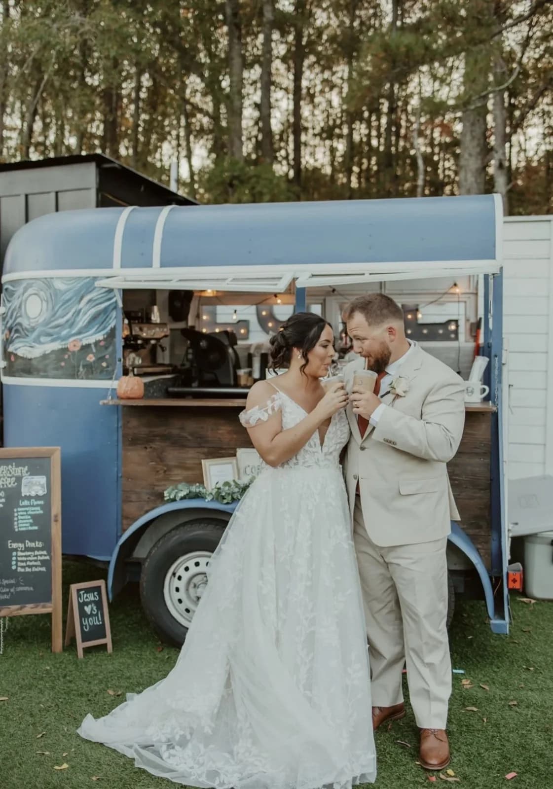 A bride and groom sharing coffee in front of Cornerstone Coffee's mobile trailer at their Georgia wedding