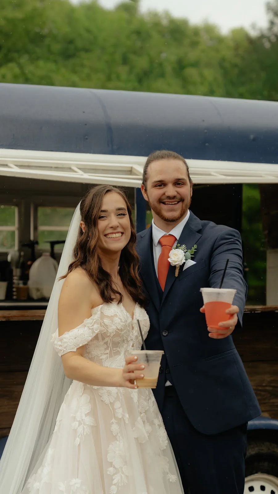 A bride and groom with iced coffees from the Cornerstone Coffee mobile bar on their wedding day
