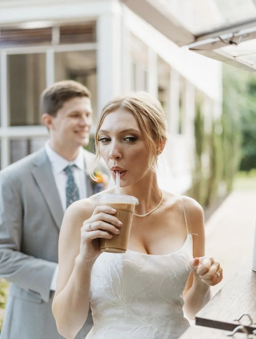 A bride sipping an iced coffee served by Cornerstone Coffee's mobile bar at her wedding