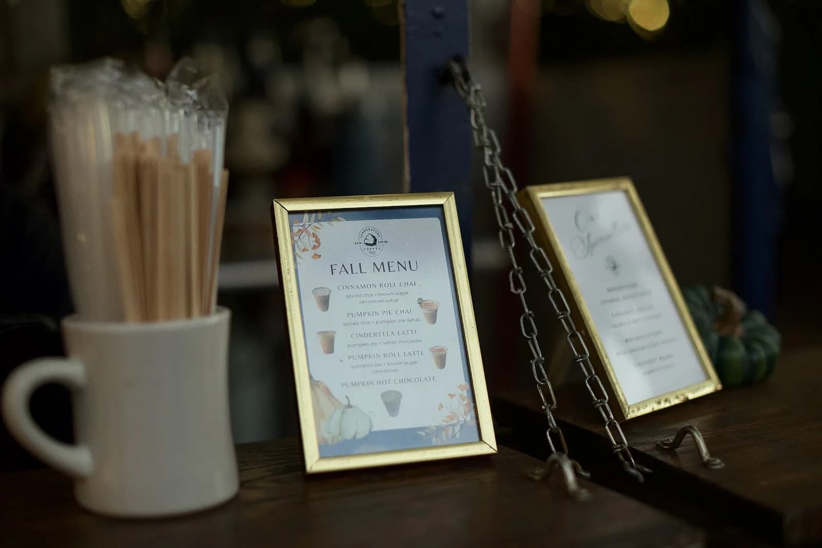 Framed menus, straws and branded mugs styled on the Cornerstone Coffee event bar