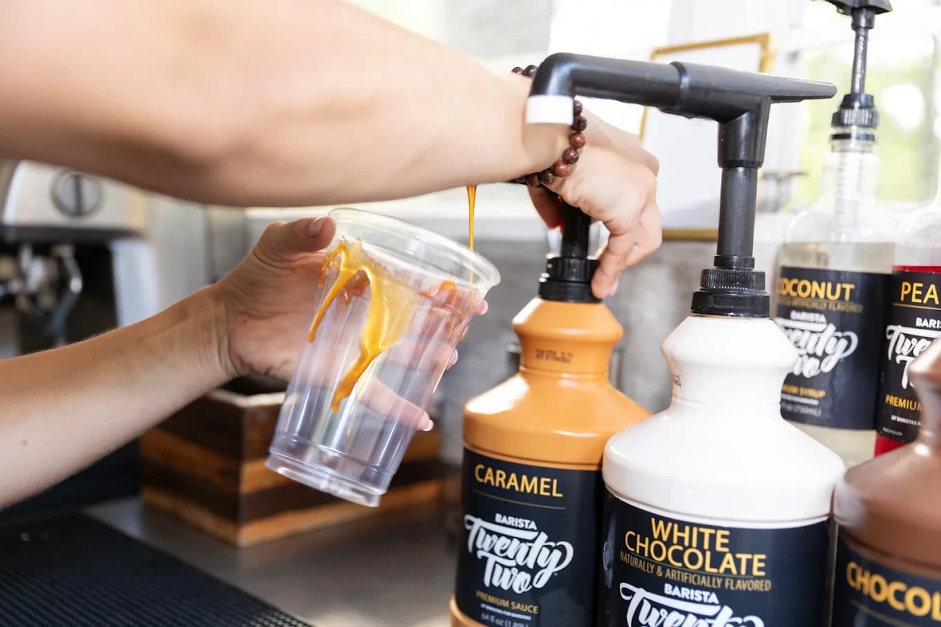 Flavored syrups lined up on the Cornerstone Coffee cart during an event