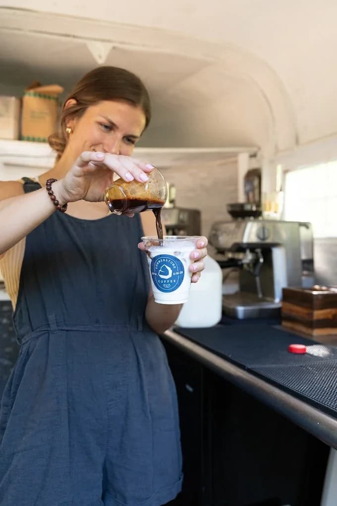 A guest enjoying an iced coffee from the Cornerstone Coffee mobile bar