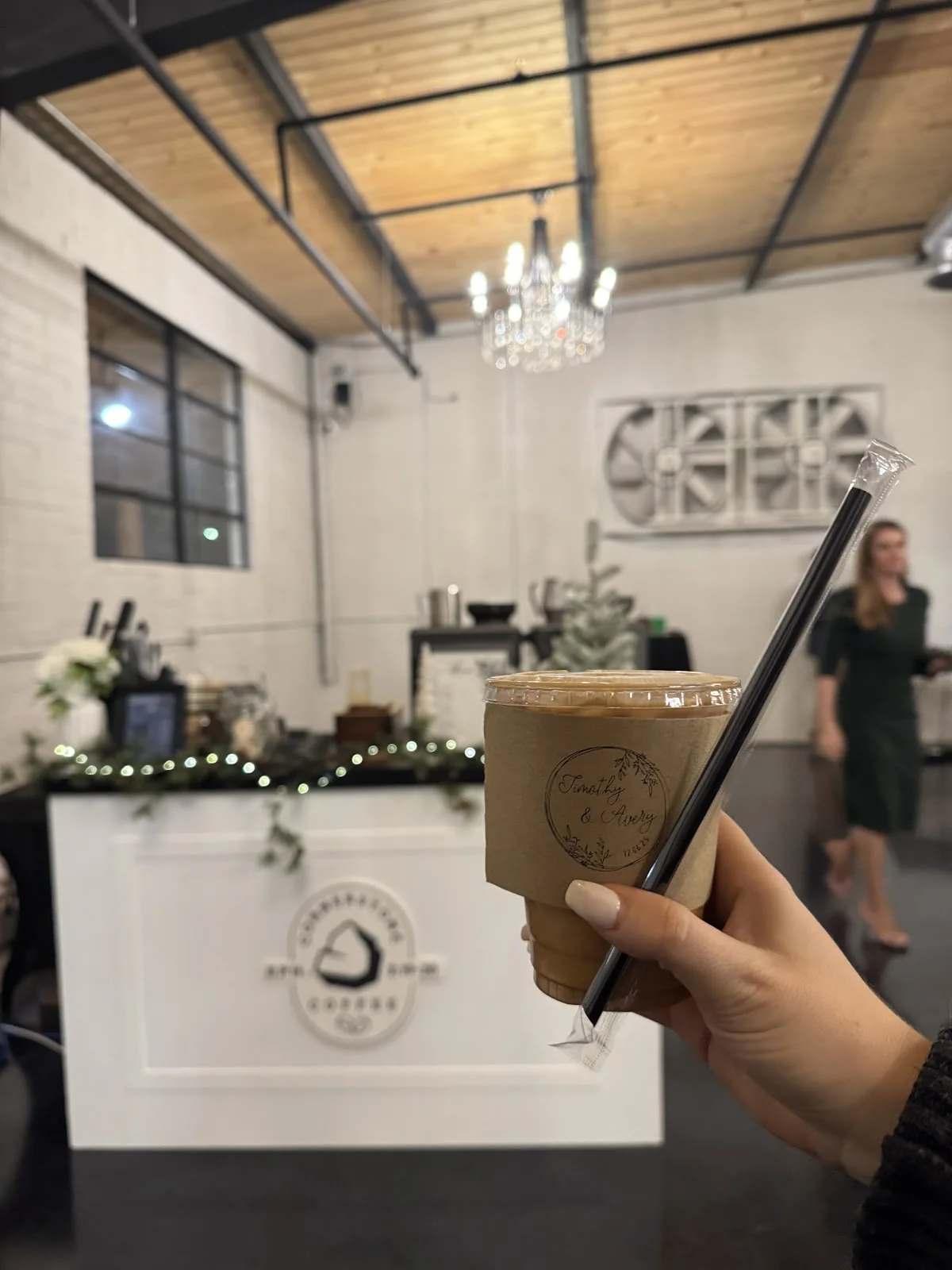A guest holding a Cornerstone Coffee iced drink inside an event venue