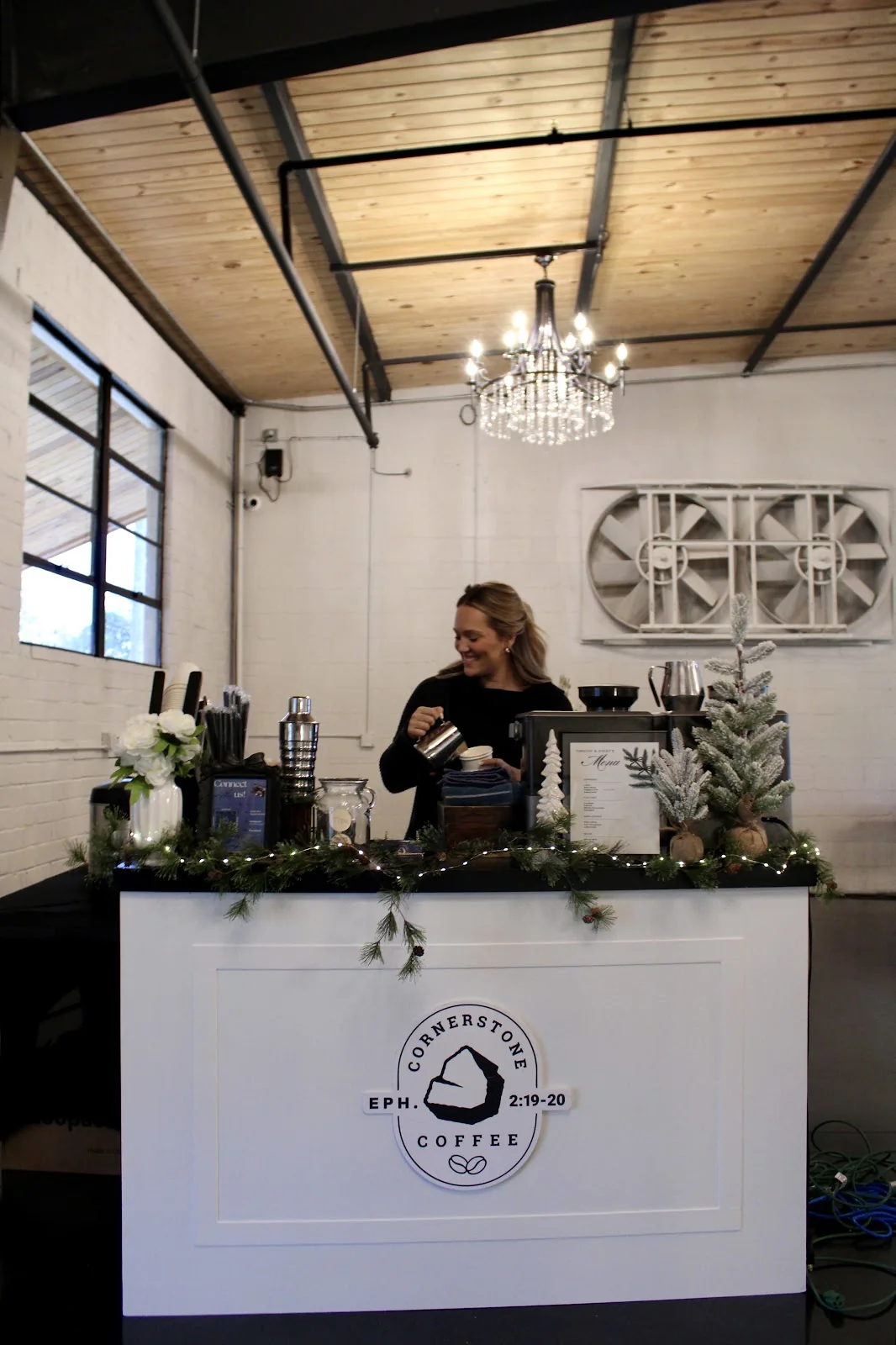 Cornerstone Coffee's white branded coffee cart set up under a chandelier at an indoor Georgia event venue